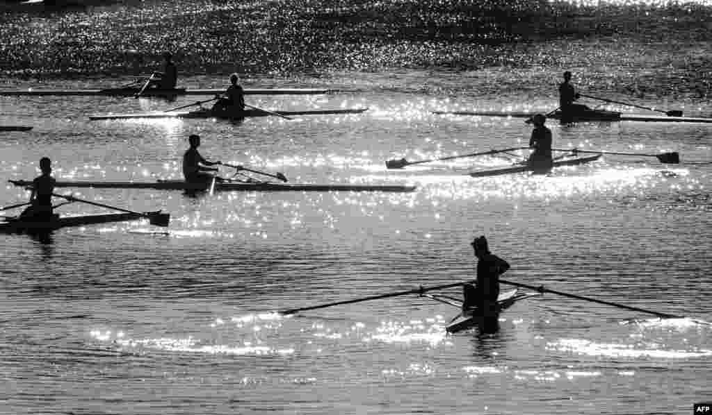 Rowers take part in a training session on the Isebek canal in Hamburg, northern Germany.