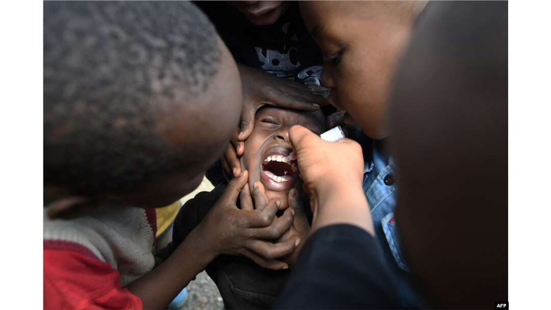 FILE - A community health worker administers a polio vaccine during a polio immunization campaign in Kiamako, Nairobi, Kenya, July 19, 2021.