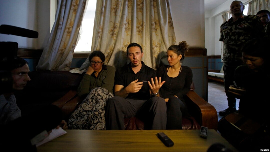 Israeli trekkers Maya Ora (R) along with Yakov Megreli (C) and Linor Kajan (L), who were rescued from an avalanche by the Nepalese army, speak with the media while undergoing treatment at the Army Hospital in Kathmandu, Nepal, Oct. 16, 2014.
