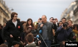 Former Greek Finance Minister Yanis Varoufakis speaks in front of supporters of social media-driven movement "Nuit Debout" (Up All Night), during their daily gathering on the Place de la Republique in Paris, France, against a French labour law proposal, April 16, 2016.