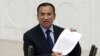 FILE - Turkish Deputy Prime Minister Bekir Bozdag, justice minister at the time, addresses Turkish lawmakers in Ankara, Turkey, March 19, 2014. Bozdag said Paris offering to mediate between Ankara and the YPG Syrian Kurdish militia amounted to supporting terrorism.