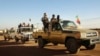 FILE - Soldiers from the Tuareg rebel group MNLA drive in a convoy of pickup trucks in the northeastern town of Kidal, Mali, February 4, 2013. 