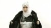 FILE - Iraqi Sajida Mubarek Atrous al-Rishawi opening her jacket and showing an explosive belt as she confesses on Jordanian state-run television to her failed bid to set off a bomb inside one of three Amman hotels targeted by al-Qaida in Jordan, Nov. 13, 2005.