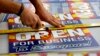 Tom Cushing, a production expert at Fast Signs, cuts down a sheet of anti-Senate Bill 1062 signs that read &quot;Open For Business To Everyone,&quot; in Phoenix, Arizona, Feb.26, 2014.