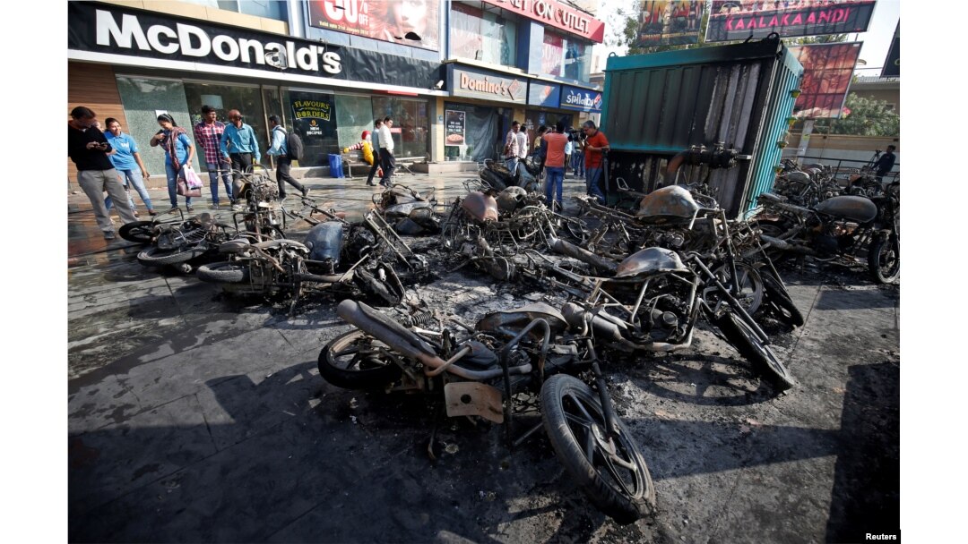 Burnt vehicles, set on fire Tuesday night following a protest by people belonging to Rajput community against the release of the upcoming Bollywood movie 'Padmaavat,' are seen outside a multiplex in Ahmedabad, India Jan. 24, 2018.