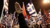 FILE - A supporter of Greece's extreme right Golden Dawn party raises his hand in a Nazi-style salute during a rally in Athens.