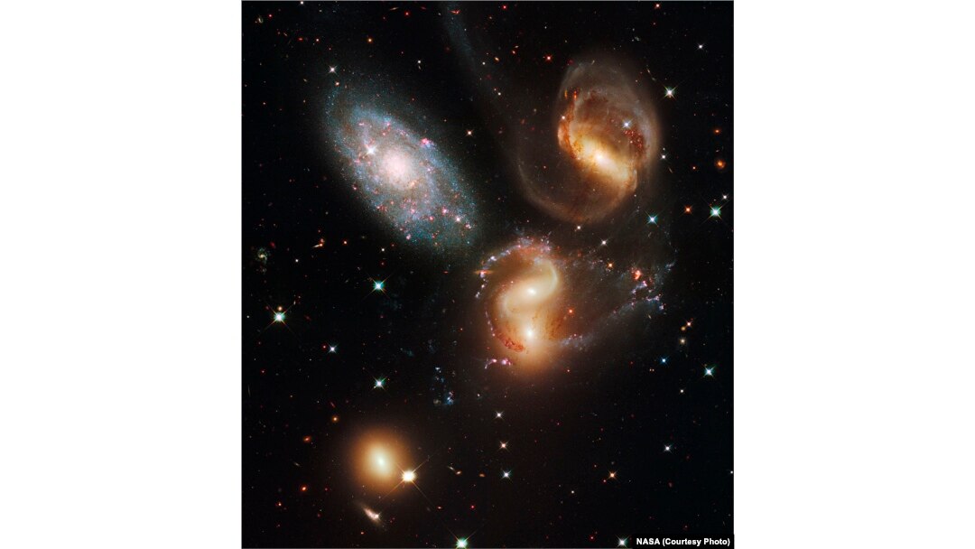Four of these five galaxies in Stephan's Quintet are so close together they are bound together by gravity and will eventually merge into a single galaxy. The galaxy at top left is in the foreground, far from the other members.