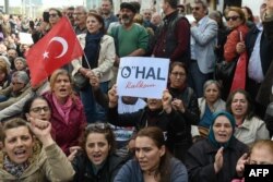 In this file photo taken on April 16, 2018, People shout "We want democracy, not state of emergency" slogans during a sit-in demonstration called by Turkey's Republican People's Party (CHP).