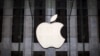 FILE - An Apple logo hangs above the entrance to the Apple store on 5th Avenue in the Manhattan borough of New York City, July 21, 2015. 