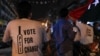 FILE - Supporters of Pakistan Tehreek-e-Insaf (PTI) political party, wearing shirts with a cricket bat logo, celebrate during the general election in Karachi, Pakistan, July 25, 2018.