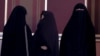FILE - Veiled Iranian women attend a conservatives campaign gathering in Tehran, Iran, Feb. 24, 2016. 