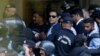 FILE - Officers escort Pakistan's former Prime Minister Imran Khan as he appears in Islamabad High Court on May 12, 2023. Pakistan's top court approved bail for Khan on Dec. 22, but because he is serving a sentence for an earlier conviction, he has not been released.