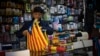 A seller organizes esteladas or independence flags to sell in a shop in Barcelona, Spain, Oct. 11, 2017.