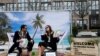 Activists stage a protest on a mock tropical island beach representing a tax haven outside a meeting of European Union finance ministers in Brussels, Belgium, Dec. 5, 2017. 