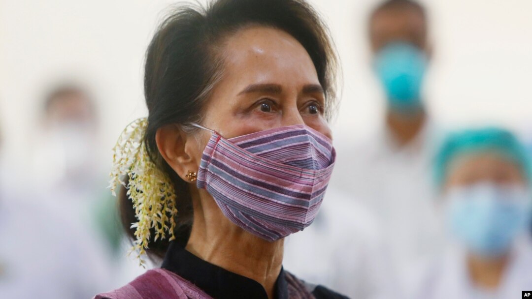 FILE - Myanmar leader Aung San Suu Kyi watches the vaccination of health workers at a hospital in Naypyitaw, Jan. 27, 2021.