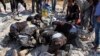This photo provided by the Syrian Civil Defense White Helmets shows civil defense workers searching in the rubble after airstrikes hit in Khan Sheikhoun, in the northern province of Idlib, Syria, Sept, 24, 2017.