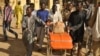 The remains of a victim of the Kano central mosque bombing are wheeled into the Murtala Mohammed Specialist Hospital in Nigeria.