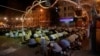 Men attend an evening mass prayer session called tarawih along a road to mark the fasting month of Ramadan in Karachi, Pakistan, May 27, 2017.