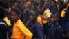 FILE - Students arrive for class at the Every Nation Academy private school in the city of Makeni in Sierra Leone.