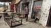 An Indian villager walks near damaged shops hit by mortar attack allegedly fired from the Pakistan’s side in Arnia Sector near the India-Pakistan international border, about 47 kilometers (30 miles) from Jammu, India, Oct. 7. 2014. 