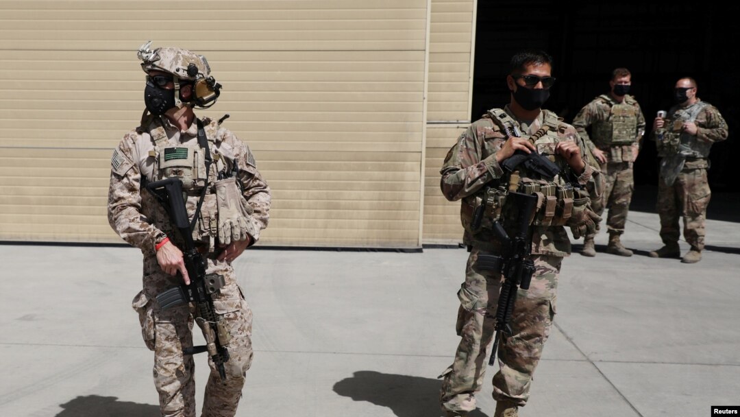 FILE - U.S. troops stand guard during a handover ceremony of A-29 Super Tucano planes from U.S. to the Afghan forces, in Kabul, Sept. 17, 2020. 