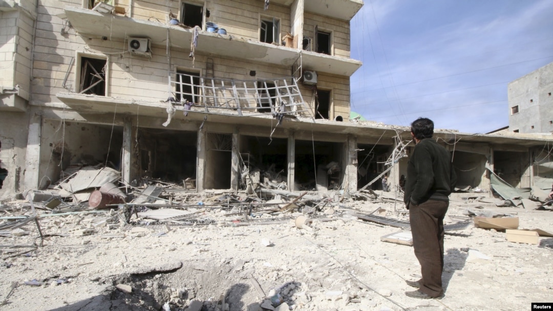 A man surveys the damage after airstrikes by pro-Syrian government forces in the rebel-held al-Sakhour neighborhood of Aleppo, Syria, Feb. 5, 2016. 