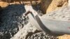 After being poured at a building site, concrete "cures" to be hard as rock
