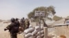 FILE - Cameroonian soldiers stand guard at a lookout post as they take part in operations against Boko Haram militants on Elbeid bridge that separates northern Cameroon form Nigeria's Borno state near the village of Fotokol, Cameroon, Feb. 25, 2015.