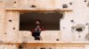 FILE - A fighter from the Free Syrian Army is seen in the Yadouda area of Dara'a, southern Syria, May 29, 2018.