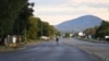 FILE - A pedestrian walks across an empty road, which usually experience heavy traffic in Gaborone on April 5, 2020 during the third day of the state of emergency in Botswana.