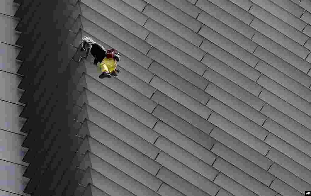 French urban climber Alaine Robert, popularly known as "Spider-man," climbs the 47-story GT Tower Building in the financial district of Makati city, east of Manila, Philippines.