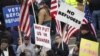 FILE - People gather to protest against the United States' acceptance of Syrian refugees at the Washington State Capitol in Olympia, Wash., Nov. 20, 2015.