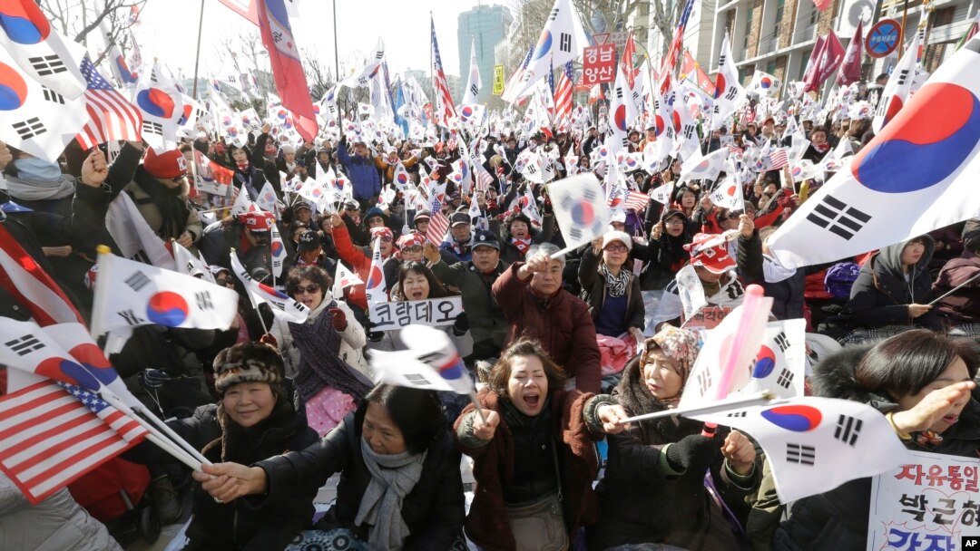 Supporters of South Korean President Park Geun-hye shout slogans during a rally opposing her impeachment near the Constitutional Court in Seoul, South Korea, Friday, March 10, 2017.