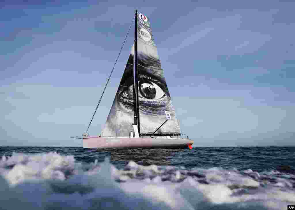 A picture taken during a training session off of the coast of Le Havre, northwestern France shows the &quot;Vivo a Beira&quot; monohull, Imoca bearing a work by French street artist JR on the sail, prior to the start of the 13th Transat Jacques Vabre sailing race, from Le Havre in France to Salvador de Bahia in Brazil. The race will start on Nov. 5, 2017.