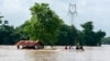 FILE - Volunteers ride a boat through a flooded area, searching for stranded people following the impact of Typhoon Yagi in Taungnoo city, Myanmar, September 17, 2024. 