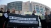 Human rights activists stage a protest outside a court in Istanbul, Turkey, Jan. 31, 2018, where a trial of eleven human rights activists, accused of belonging to and aiding terror groups, is ongoing.