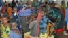 Women and children crowd around the public water taps at the Dollo Ado refugee transit facility in Ethiopia, October 26, 2011. (VOA - P. Heinlein)