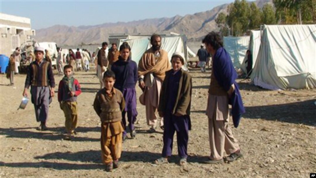In this photo taken on Jan. 31, 2011, displaced Pakistanis arrived at a camp set up in Naghi, 18 kilometers northwest of the Afghanistan border in the Pakistani tribal area of Mohmand.