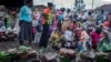 Ethiopians from different towns in the Amhara region wait for food to be distributed at lunchtime at a center for the internally displaced in Debark, in the Amhara region of northern Ethiopia, Aug. 27, 2021.