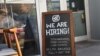 FILE - A 'We are hiring sign' in front of the Buya restaurant in Miami, Florida, March 5, 2021. 