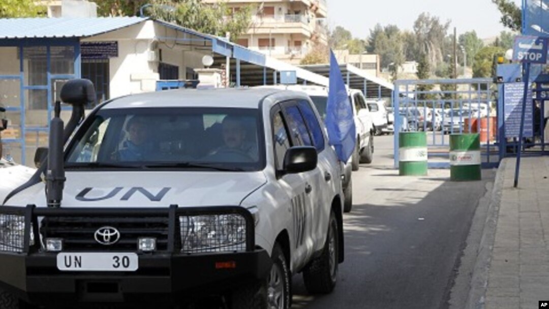 United Nations (UN) observers traveling in UN vehicles leave the UN office in Damascus, April 26, 2012