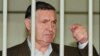FILE - Mafia "boss of bosses" Salvatore "Toto" Riina is seen behind bars during a trial in Rome, April 29, 1993. Riina has died while serving multiple life sentences. He was 87.
