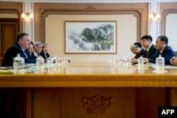 U.S. Secretary of State Mike Pompeo, left, speaks during a meeting with North Korea's director of the United Front Department, Kim Yong Chol, right, at the Park Hwa Guest House in Pyongyang, July 6, 2018.