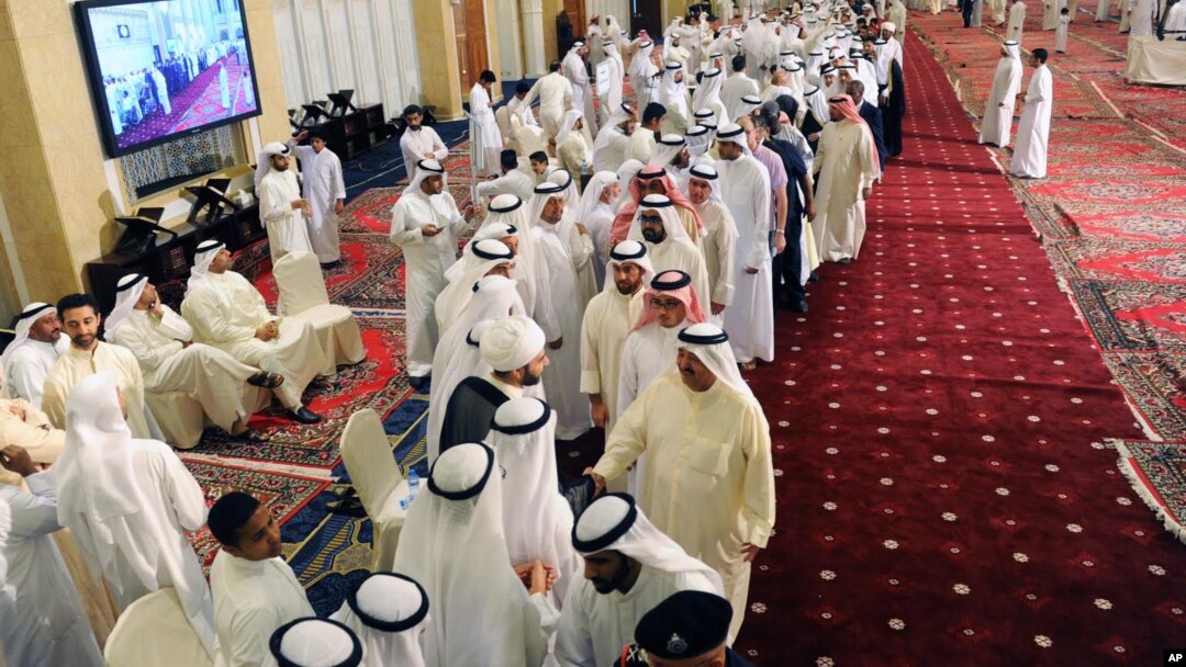 Kuwaitis queue at the Grand Mosque to pay their respects and condolences to the families of victims of a terrorist attack claimed by the Islamic State group on the Shiite Imam Sadiq Mosque in Kuwait City during Friday prayers, June 28, 2015.
