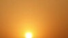 The sun rises behind electricity pylons in Beijing, China.