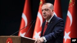 FILE - Turkey's President Recep Tayyip Erdogan announces early presidential and parliamentary elections for June 24, 2018, at the Presidential Palace, in Ankara, Turkey, April 18, 2018. 