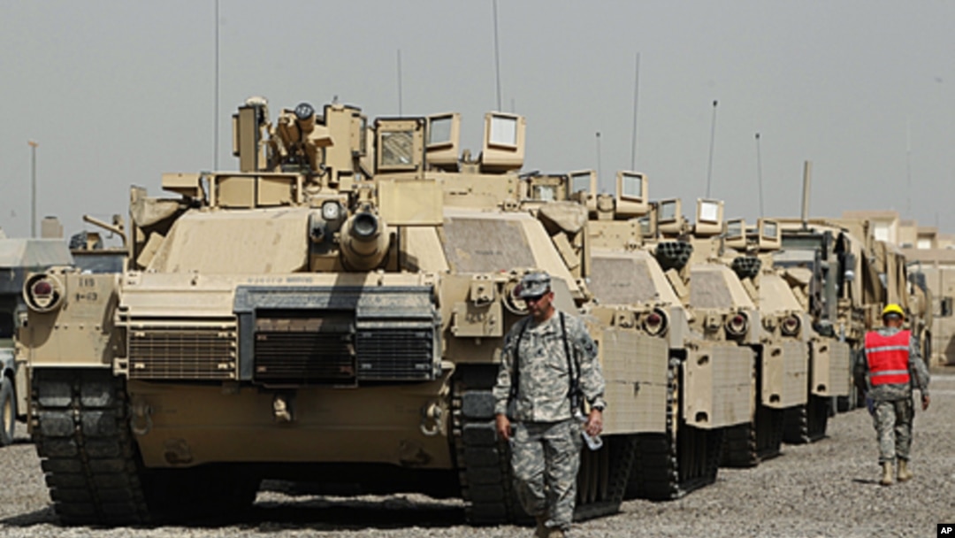 U.S. soldiers walk past tanks at a courtyard at Camp Liberty in Baghdad. U.S troops are scheduled to pull out of the country by the end of this year, according to a 2008 security pact between the U.S. and Iraq. (File September 30, 2011).
