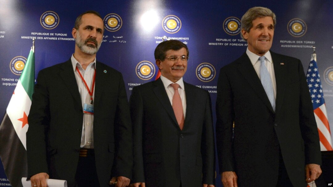 U.S. Secretary of State John Kerry, right, Turkish FM Davutoglu, center, and Syrian opposition leader Moaz al-Khatib pose for photos after a "Friends of Syria" group meeting, April 21, 2013, in Istanbul, Turkey.