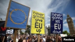 FILE - Protestors hold banners in London's Parliament Square during a 'March for Europe' demonstration against Britain's decision to leave the European Union, July 2, 2016. 