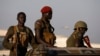 FILE - SPLA soldiers stand in a vehicle in Juba.